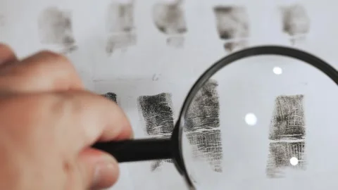 Fingerprint samples under a magnifying glass. Stock Footage 316727342