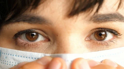 Fingers adjust the protective mask to the shape of the nose, face close-up Stock Footage 129666913