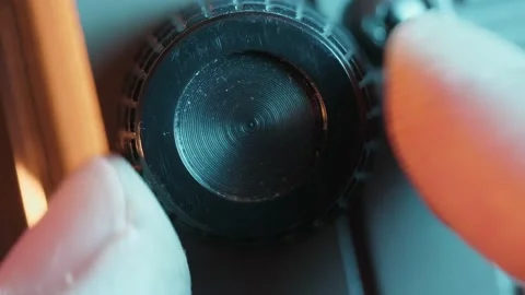 Fingers Adjusting a Knob Button Close up Micro Shot Stock Footage 148240371