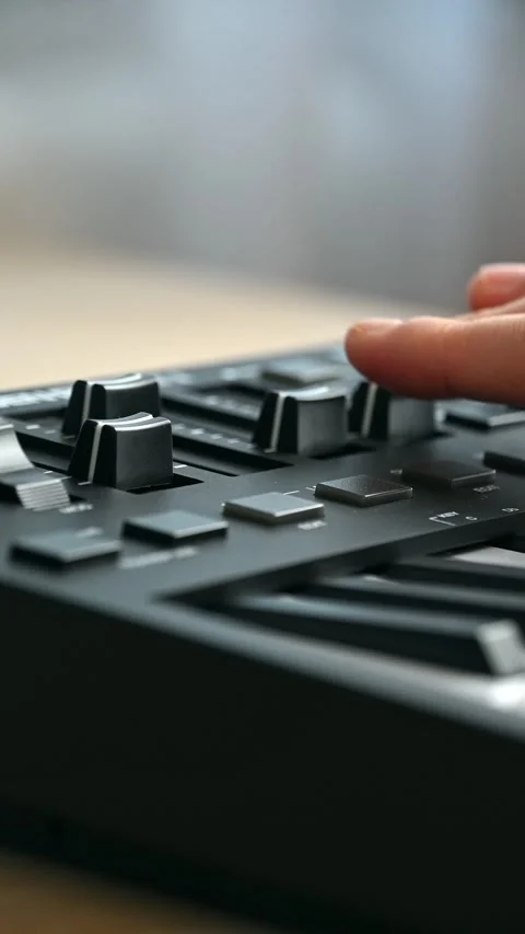 Fingers adjusting mixer knobs on home studio desk during production 스톡 동영상 331573376