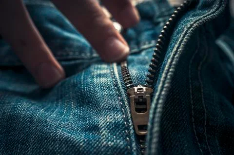 Fingers on Button and Elements of Denim Blue Jeans Metal Zipper. Stock Photos