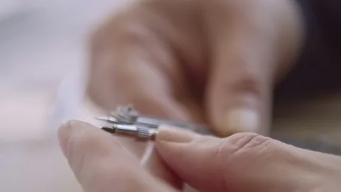 Fingers carefully prepare precision compass for drafting, macro, 4k Stock Footage 154837779