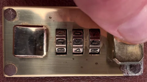 Fingers closing the latch of a three number brass combination lock. Stock Footage 281578431