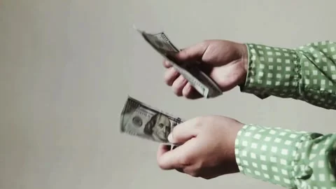 Fingers counting a stack of dollar bills on a white background. hands count.. Stock Footage 266470857