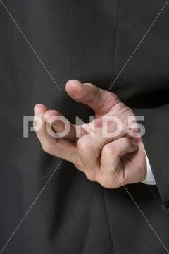 Fingers Crossed Behind Businessman's Back