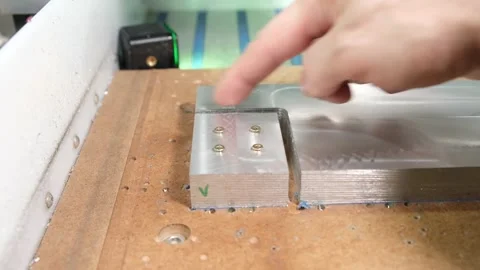 Fingers demonstrate the machine's precision cutting and alignment Stock Footage 314815774