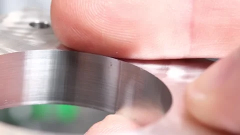 Fingers demonstrate the machine's precision cutting and alignment Stock Footage 314815900