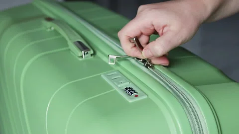 Fingers enter the code on the suitcase lock. Stockbeeldmateriaal 311562297