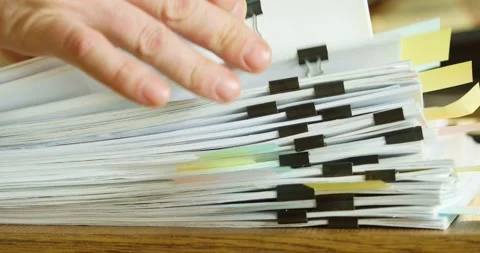 Fingers fingering a large stack of paper documents. Stock Footage 234281615