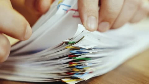 Fingers fingering large stack of paper documents. person work sorts through Stock Footage 333774187