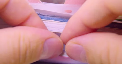 Fingers flipping through a stack of documents. Stock Footage 334944619