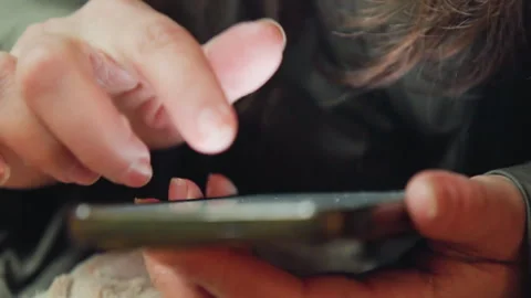 Fingers gently interact with illuminated phone screen. Closeup view capturing Stock Footage 337372937