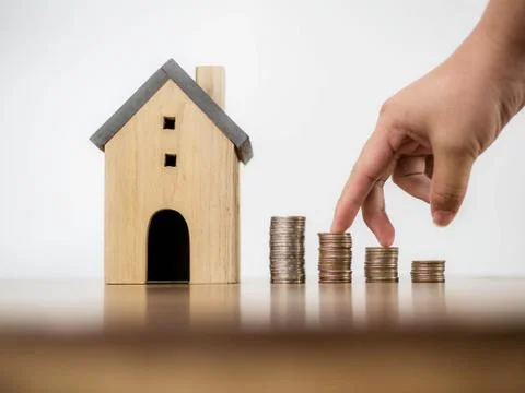 Fingers hand step forward on stack of coins and model house Stock Photos