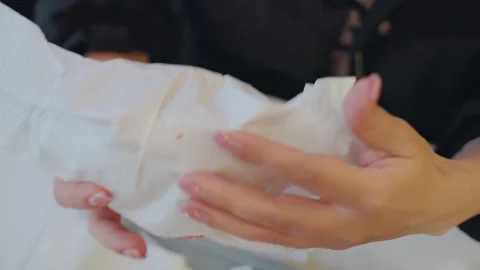 Fingers hide burger subtly behind wrapper. Intense motion as hands secretly Stock Footage 332164433