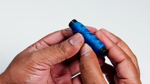Fingers Hold Blue Thread And Needle Stock Footage 248702278