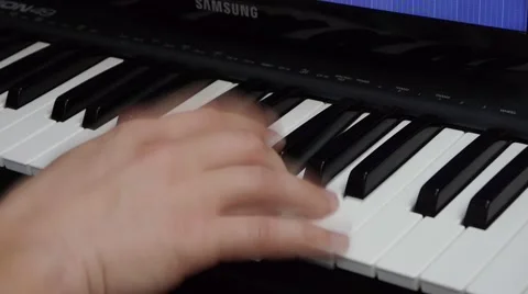 Fingers on the keys of a synthesizer Stock Footage 64274756