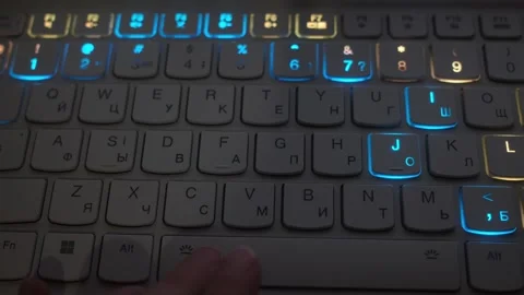 The fingers move on the computer keyboard, which is lit up in the darkness Stock Footage 318790958