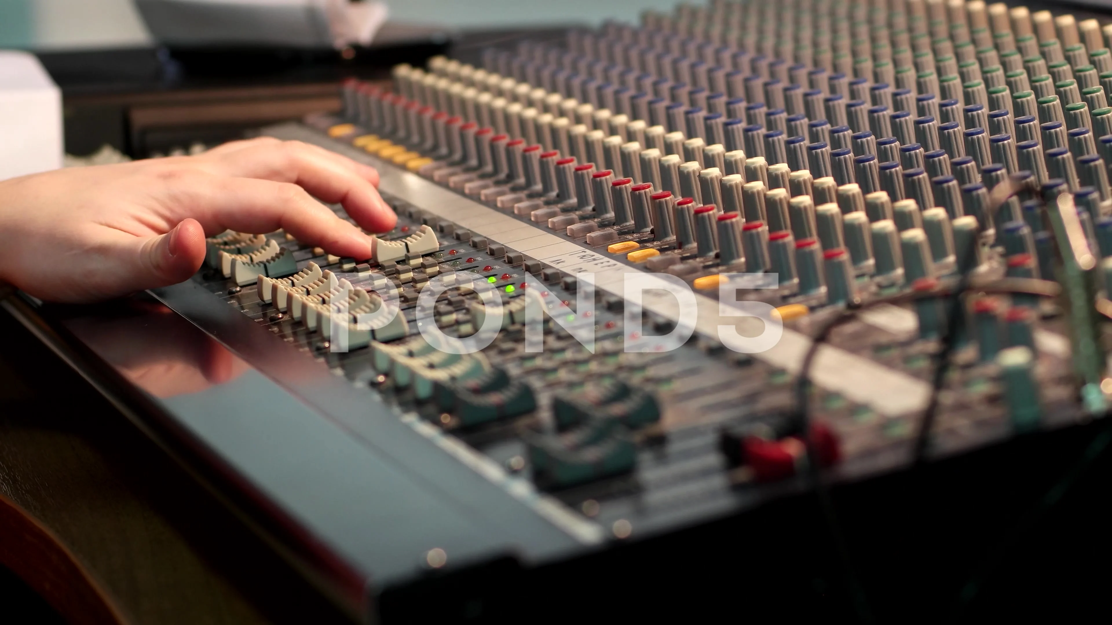 Male Finger on Audio Mixer Slider Button. Focus Selected on the