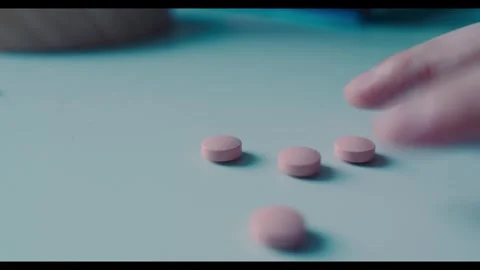 Fingers Nervously Tapping Next to Medication on a Table Stock Footage 341625712