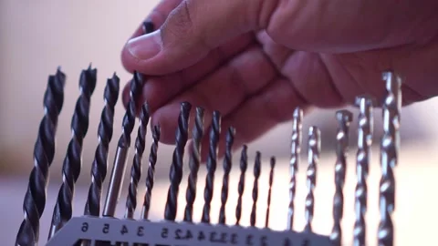 Fingers placing drill bit into sorted case, hardware tool storage, DIY workshop Stock Footage 346222281