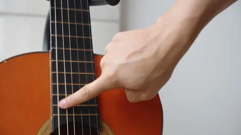 Fingers Playing Classical Guitar Strings on Fretboard Stock Footage 317790070