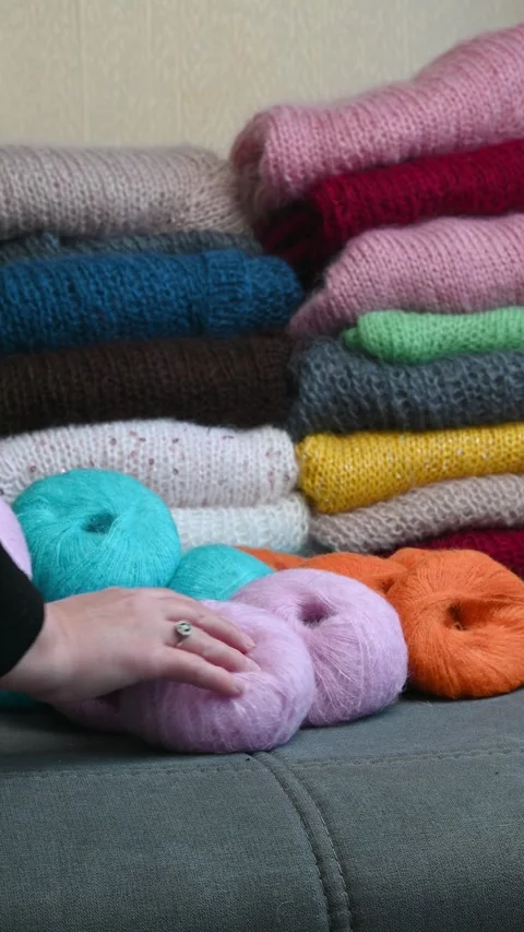 Fingers pointing toward soft yarn balls. Stock Footage 334749413
