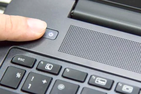 Fingers with pressing the button off the computer. Stock Photos