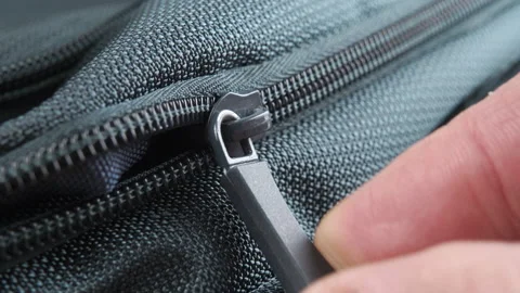 Fingers pull the zipper lock and close the green textile backpack Stock Footage 152143774
