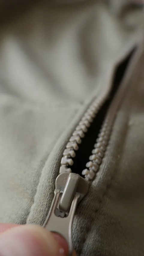 Fingers Pulling Zipper Slider Up on Olive Green Casual Clothing 動画素材 338097631
