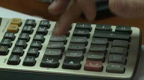 Fingers pushing bottons on a calculator Stock Footage 43335512