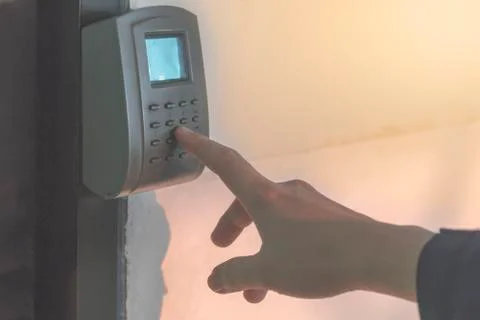 Fingers put on the security code at the door. Stock Photos