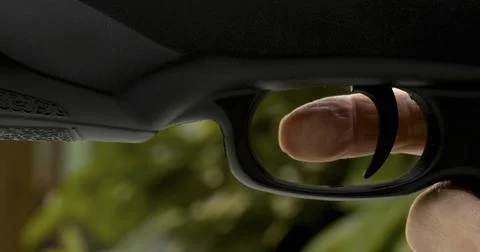 Fingers ready to pull trigger on firearm while sitting in a natural setting duri Foto stock