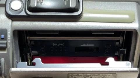 Fingers Remove Small MiniDV Tape From Camcorder Ejection Tray In Studio Stock Footage 329455736