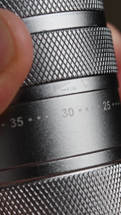 Fingers rotate the numbered grind ring on a manual coffee grinder in a vertical Stock Footage 346743659