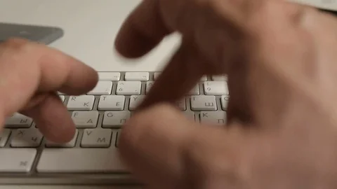 Fingers of a Russian programmer or hacker typing on a white computer keyboard Stock Footage 74492357