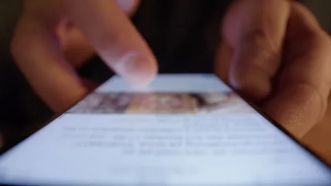 Fingers scrolling mindlessly on smartphone social media app, digital addiction 動画素材 301186751
