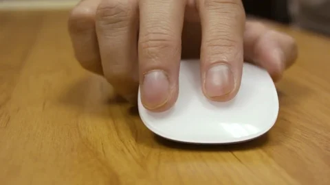 Fingers sliding up and down a clean white mouse. Stock Footage 79237017