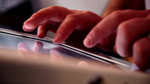 Fingers tapping on iPad inputting information Stock Footage 150846506