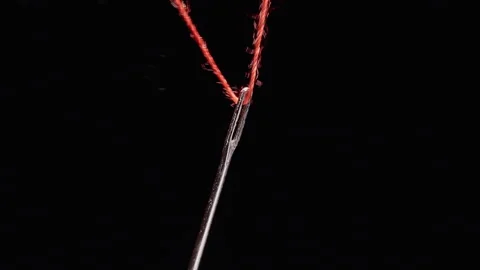 Fingers Thread Red Thread Through a Sewing Needle Against Black, Detailed Macro Stockbeeldmateriaal 341416862