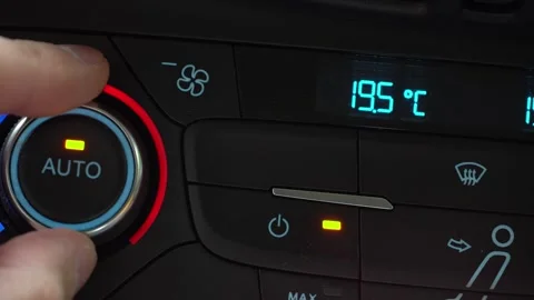 Fingers turn toggle switch of car air conditioner decreasing temperature in 库存影片 247713474
