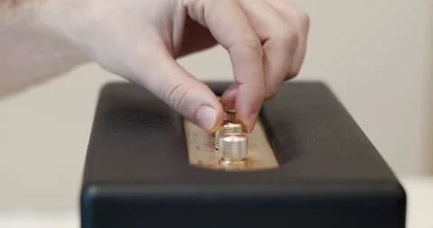 Fingers turning control knobs for audio settings on a bluetooth loudspeaker Video stock 147229293