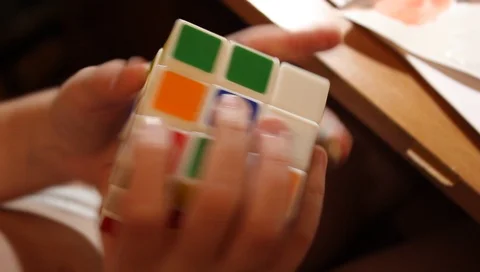 Fingers twist the dice cube, puzzle game, closeup Video stock 101407481