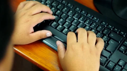 Fingers typing on black computer keyboard, camera swipes across until mobile pho Stock Footage 58110671