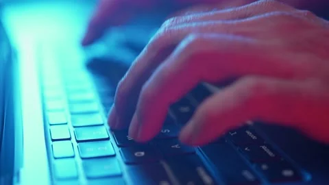 Fingers Typing on a Laptop Computer Keyboard in Darkness Video stock 158646906