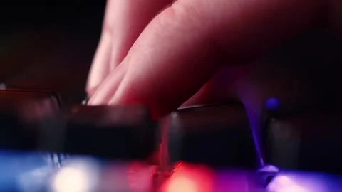 Fingers typing on the led rgb keyboard in the dark room.  Male hands is typ.. Stock Footage 234792806