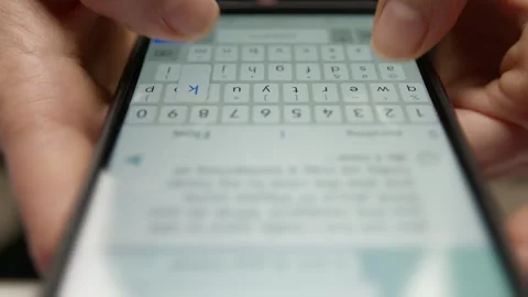 Fingers typing the message text on the phone screen.  Stock Footage 260753511