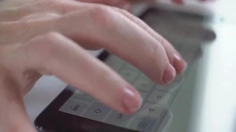 Fingers typing quickly on a digital tablet virtual keyboard Video stock 333835436