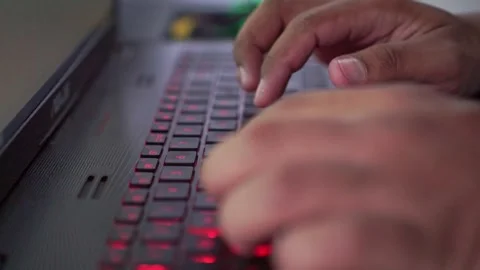 Fingers typing quickly on glowing keyboard, Vidéo 334420531
