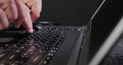 Fingers typing text on a laptop keyboard Stock Footage
