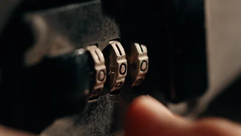 Fingers unlock the secret code to open a black briefcase in office Stock Footage 336236233